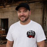 Man wearing a white t-shirt with a graphic design in an industrial setting